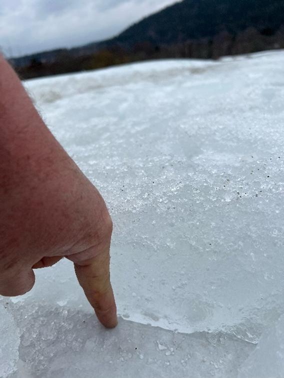 a person pointing at ice on the ground
